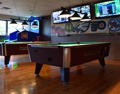 View of Two Pool Tables at the Bar