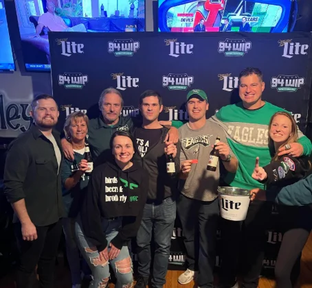 A crowd cheering for their favorite sports team at a sports bar